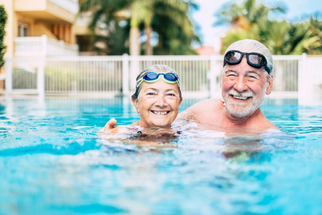 couple swimming in retirement community