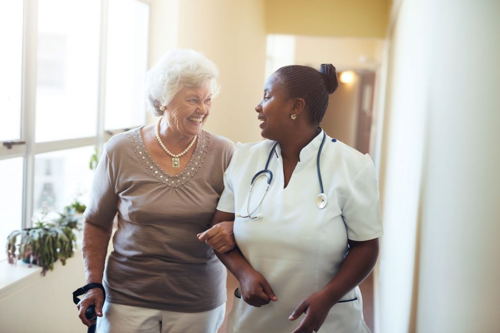 resident and assistant walking in nursing home in ohio