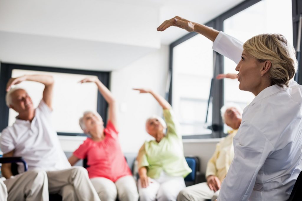 assisted living residents doing group exercise