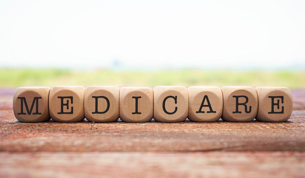 Wooden blocks spelling out Medicare enrollment