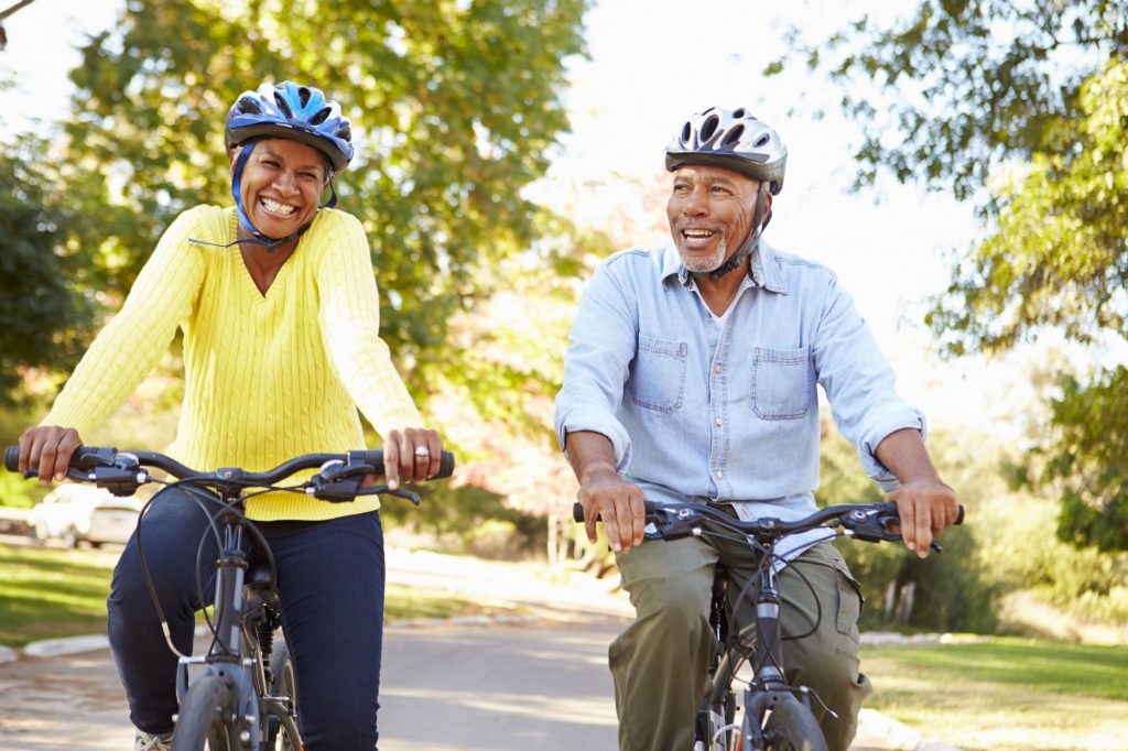 black senior couple on bikes outside