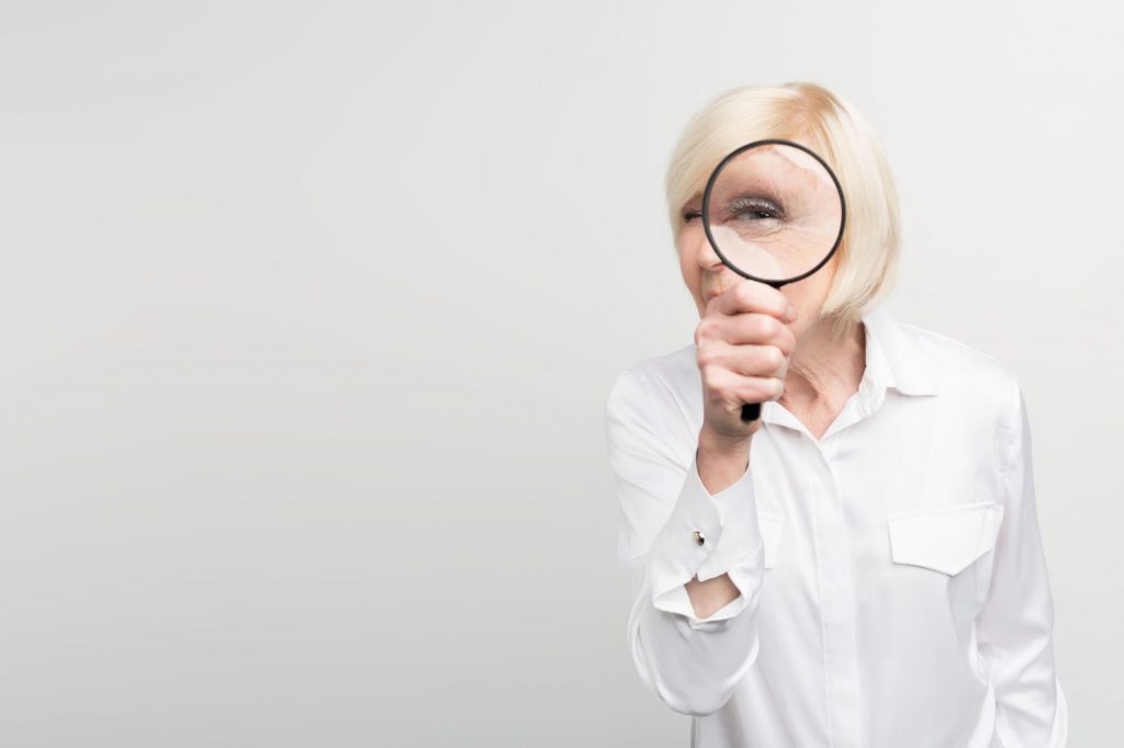 lady looking through magnifying glass