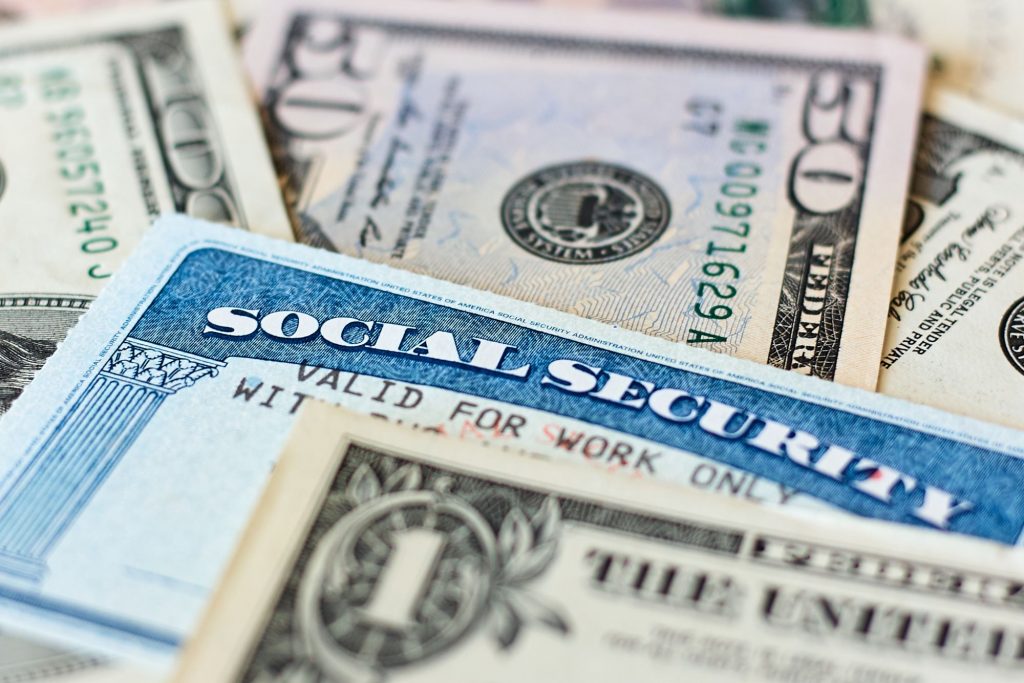 social security card with dollar bills