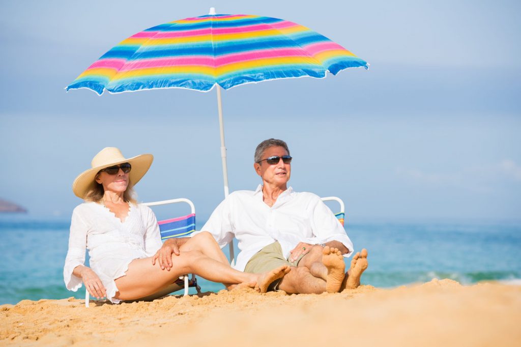 retired beach couple lounging in the sun