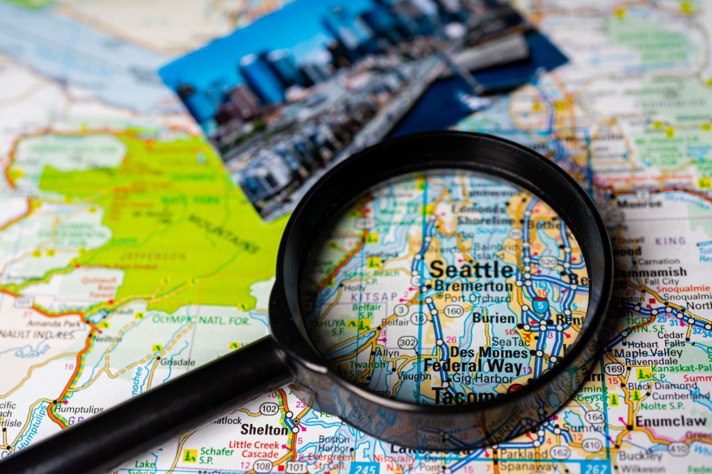 Seattle, Washington map with magnifying glass and photo of Seattle
