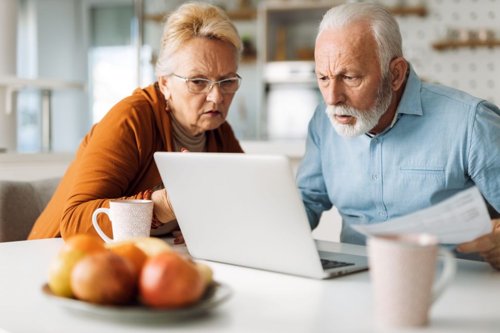 senior couple confused and looking at a computer screen