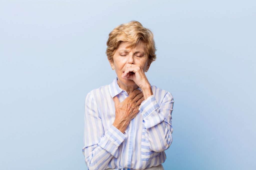 senior woman coughing