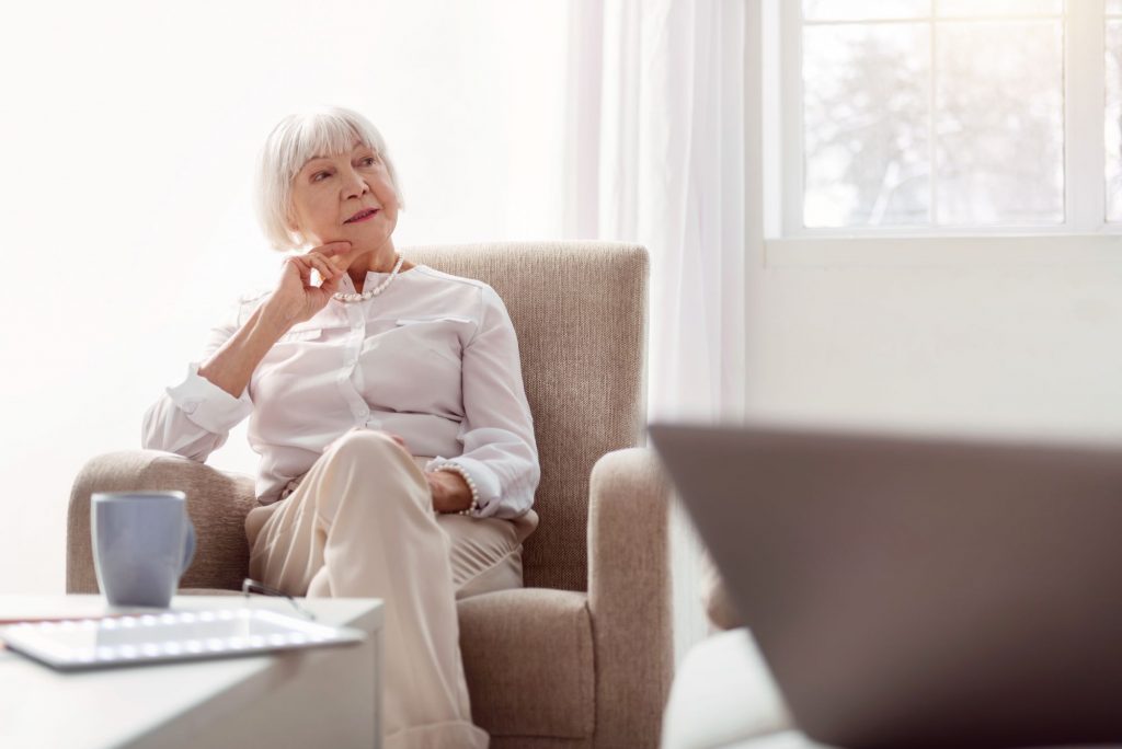 Senior Woman sitting in an armchair thinking, Medicare Part B