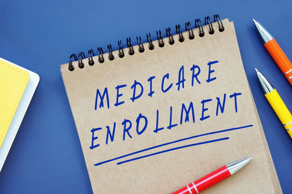 Medicare enrollment written on a notepad with pen