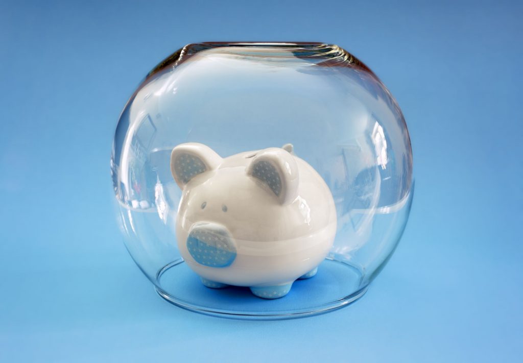 piggy bank being protected in a fishbowl