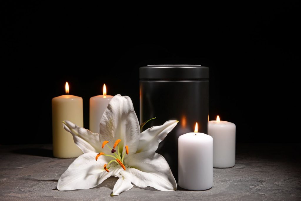 urn with decorative flowers and candles