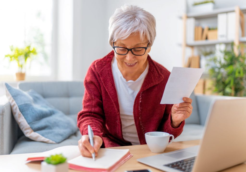 senior woman using a Social Security calculator on computer