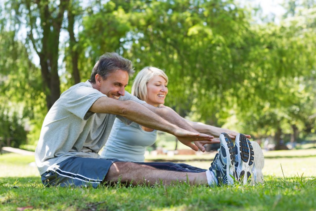 retired couple exercising at the park