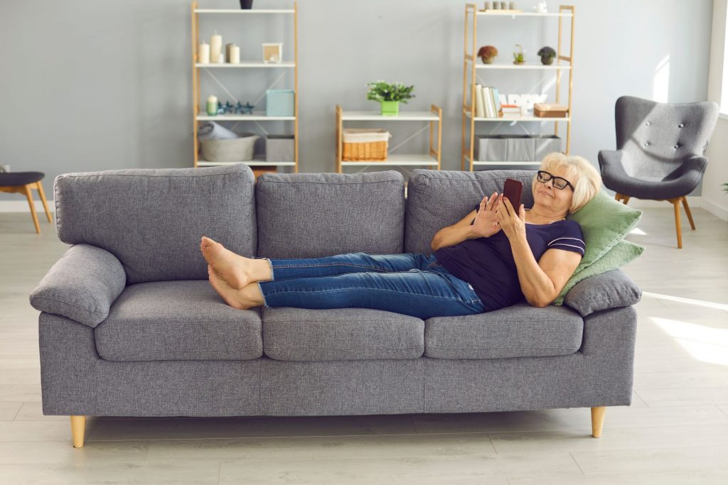 woman resting on the couch recovering from surgery