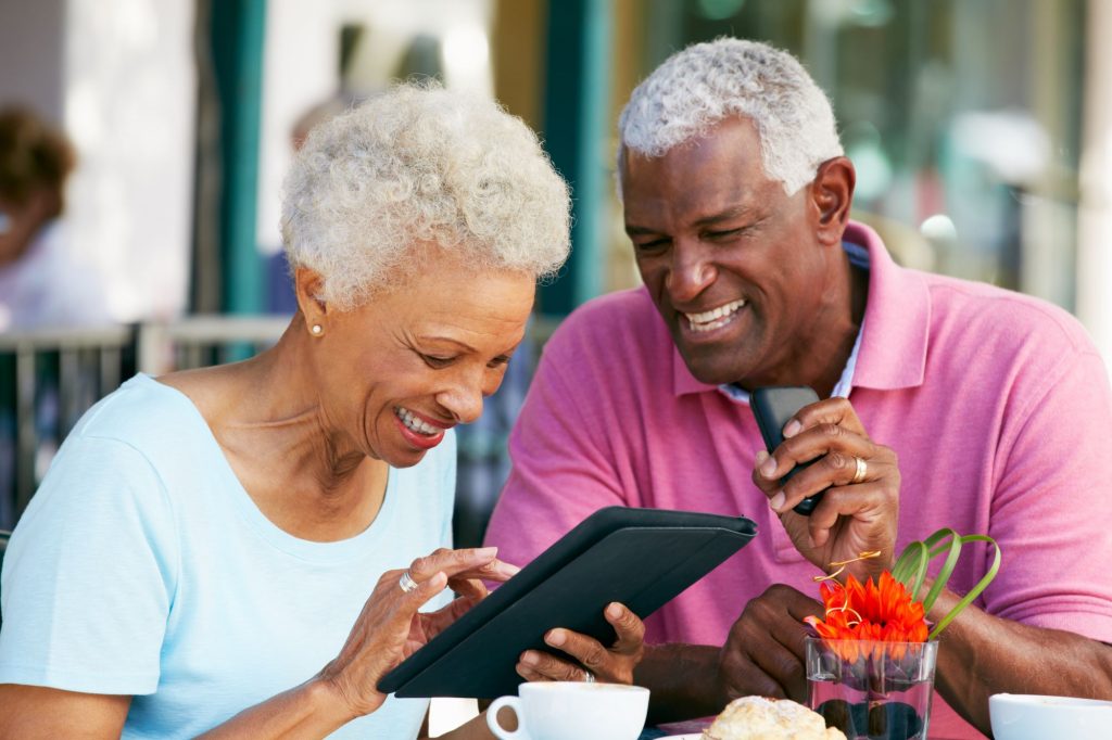 senior couple using a tablet, working on their own to-not-do list