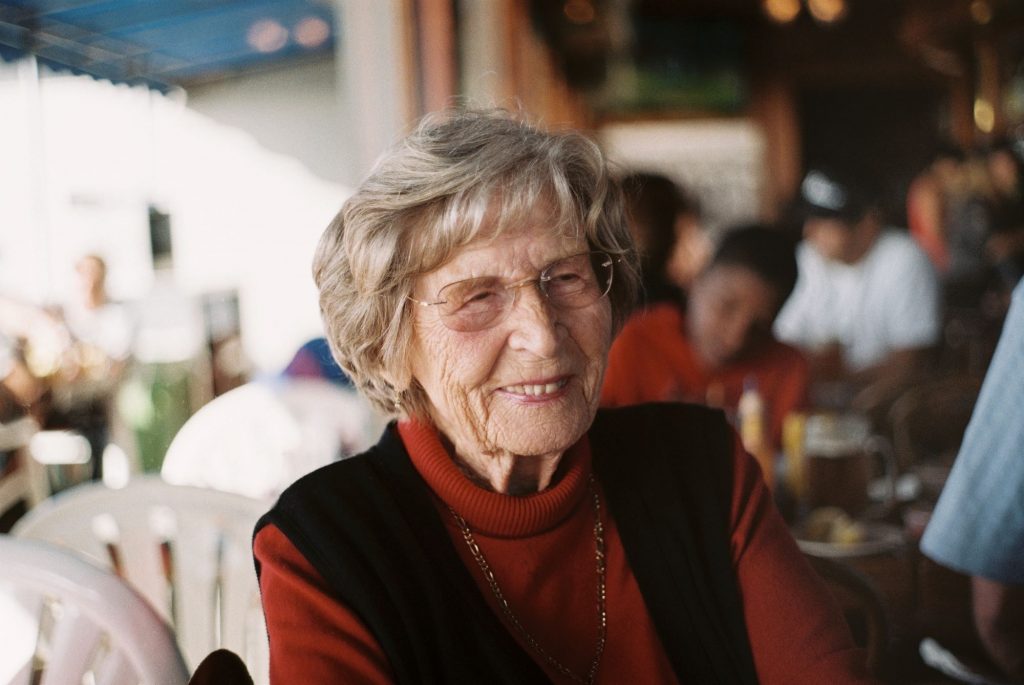 smiling elderly woman in red sweater