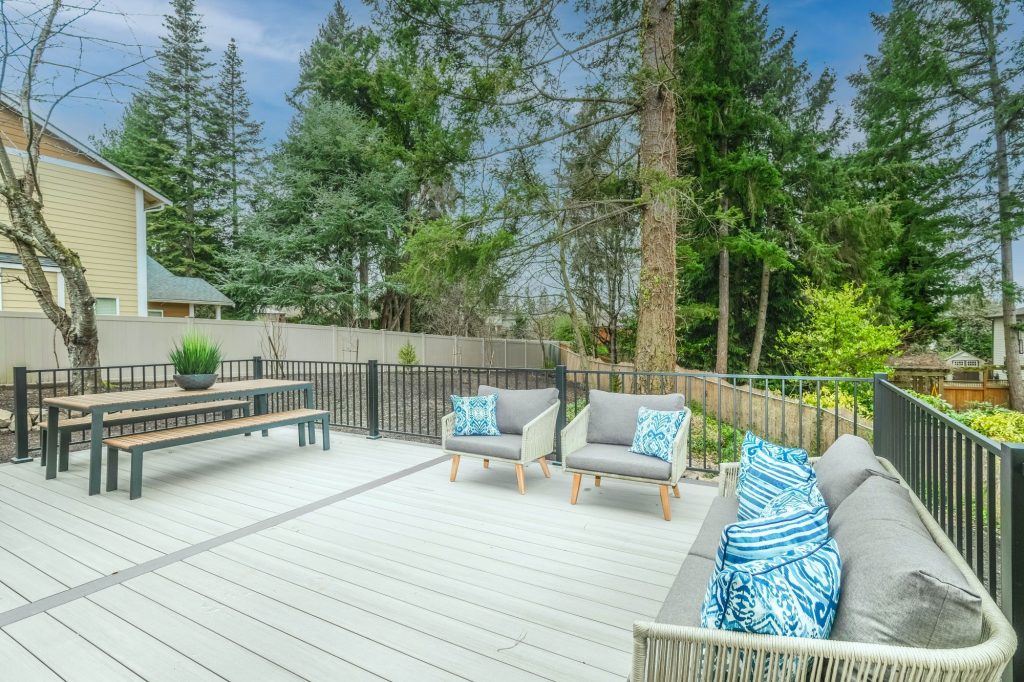 A beautifully sanded deck overlooking pine trees.