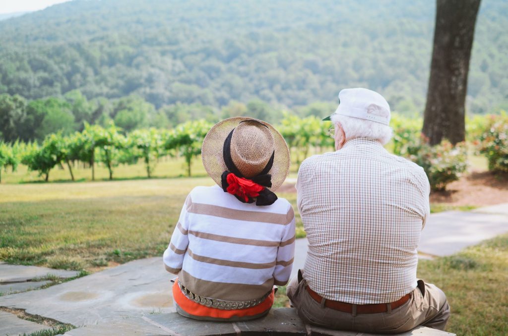 Older couple enjoying the view of vineyards.