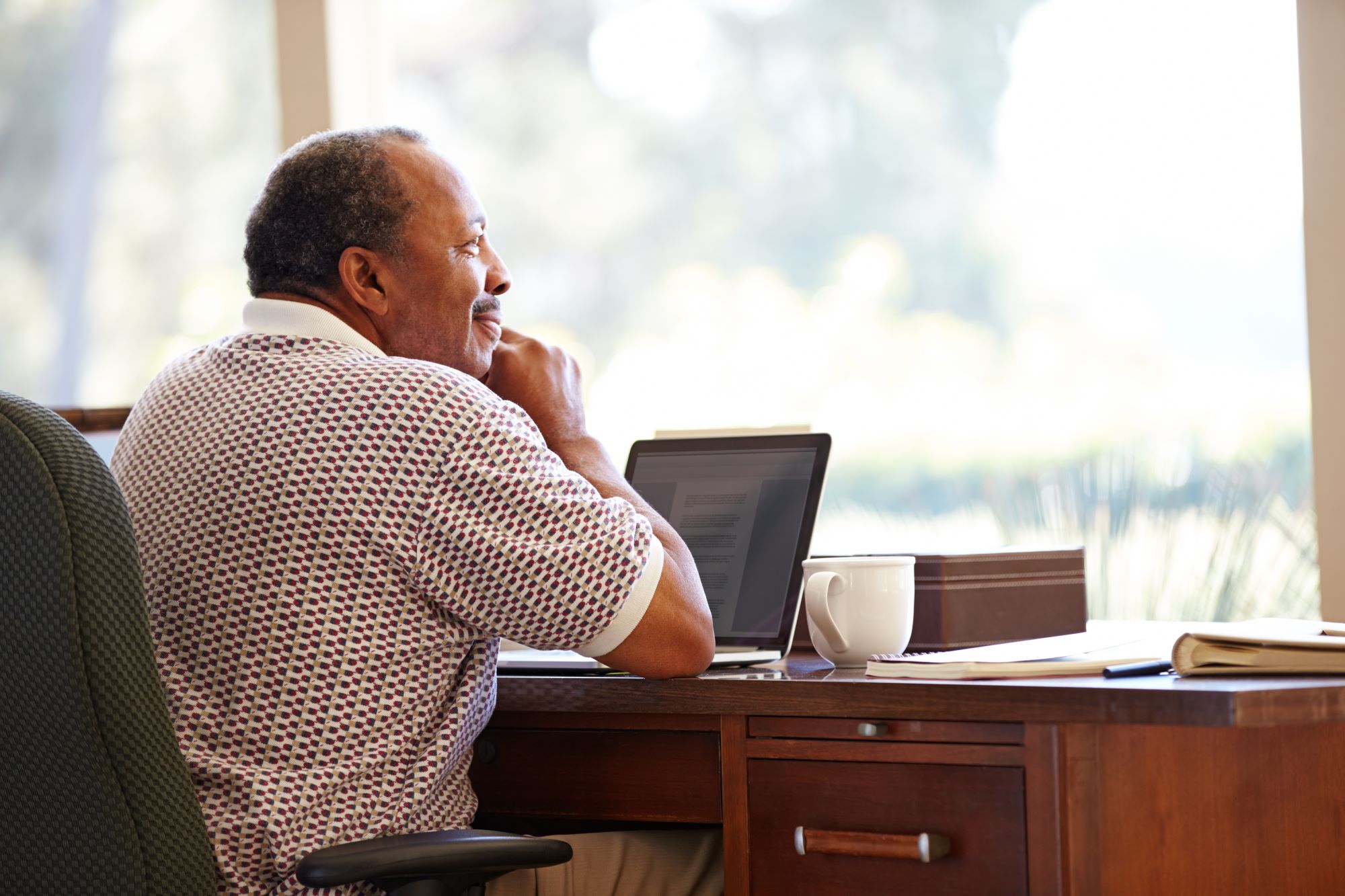 African American over 65 man sitting at desk working
