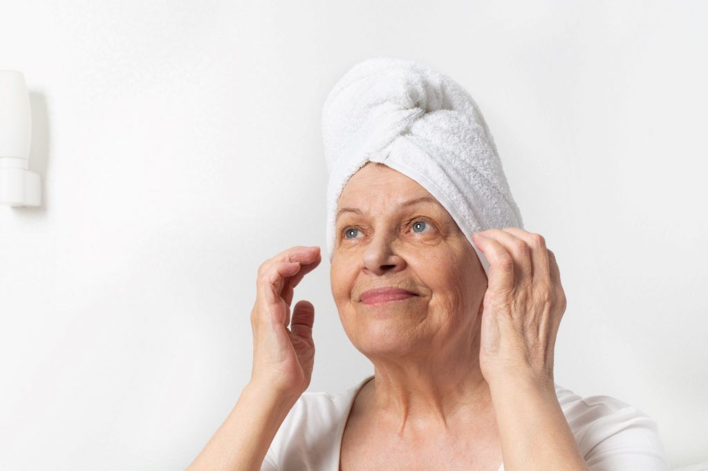 senior woman with towel on hair