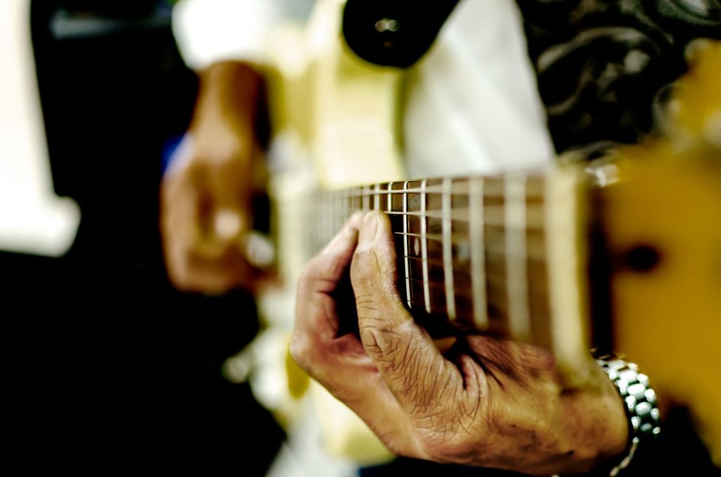 close up of a guitar being played