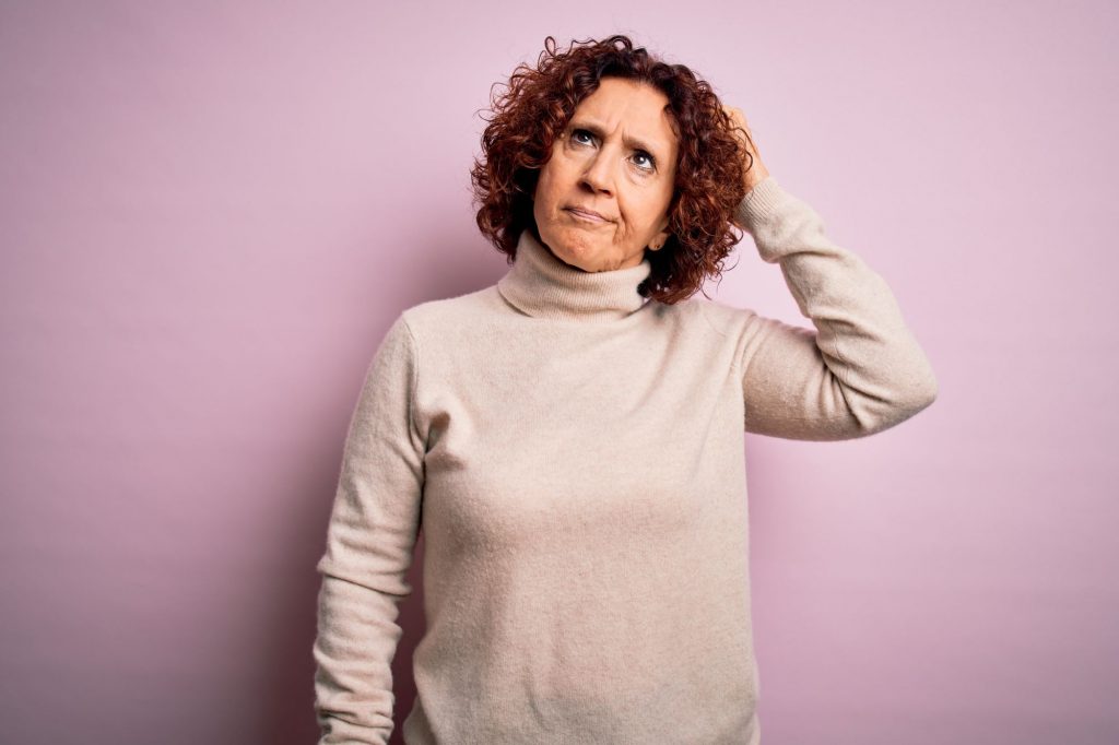 confused hispanic woman who doesn't understand Medicare enrollment