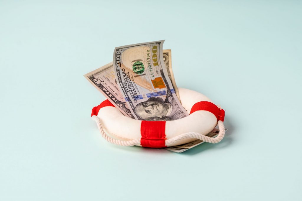 money in the middle of a life saver, life insurance policy artistic picture
