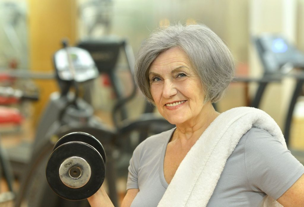 senior woman lifting a weight