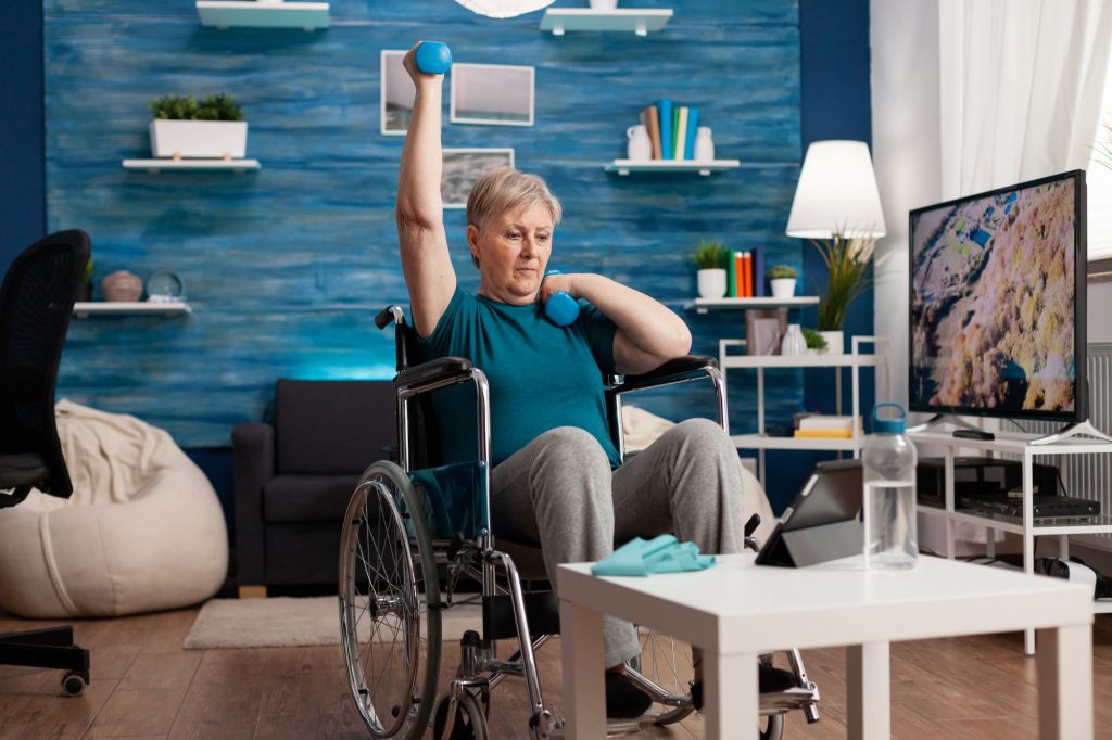 senior woman in wheelchair lifting weights