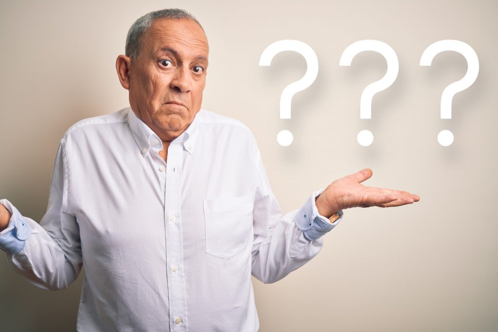 man shrugging with question marks