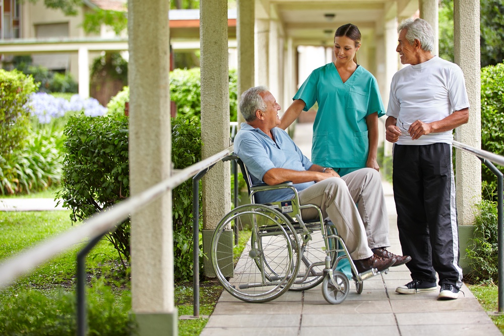 wheelchair and nurses outside nursing home