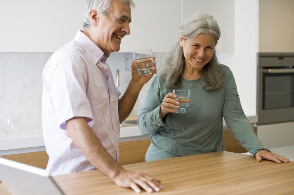 drinking water senior couple with good health and wellness