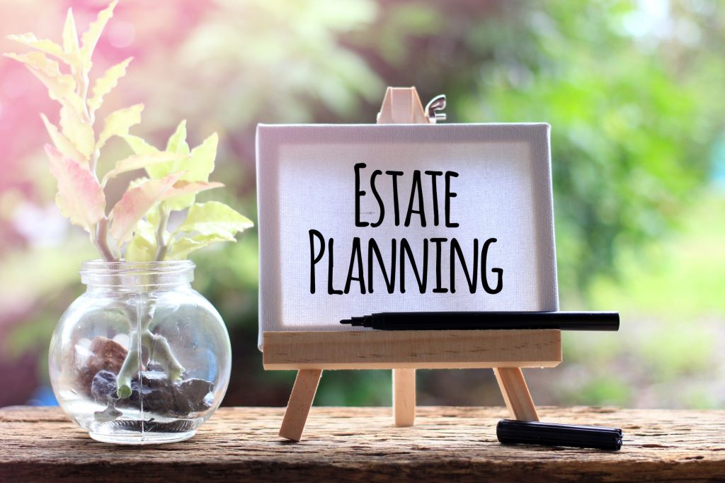 Estate Planning written on a small easel next to a houseplant