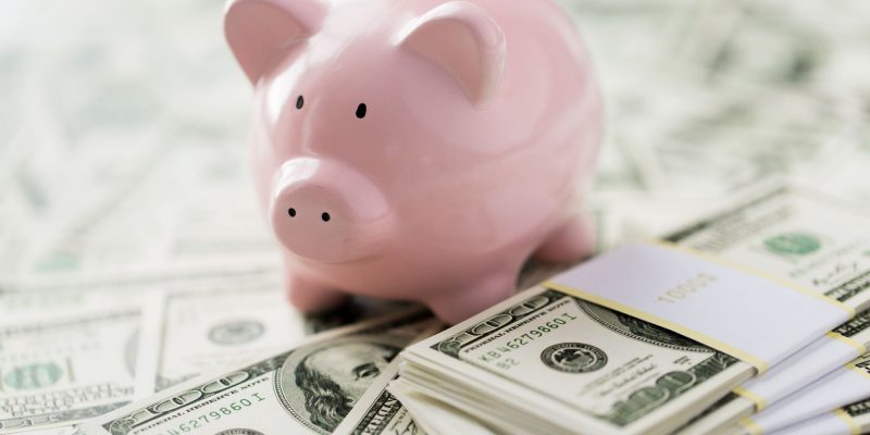 piggy bank and dollar bills