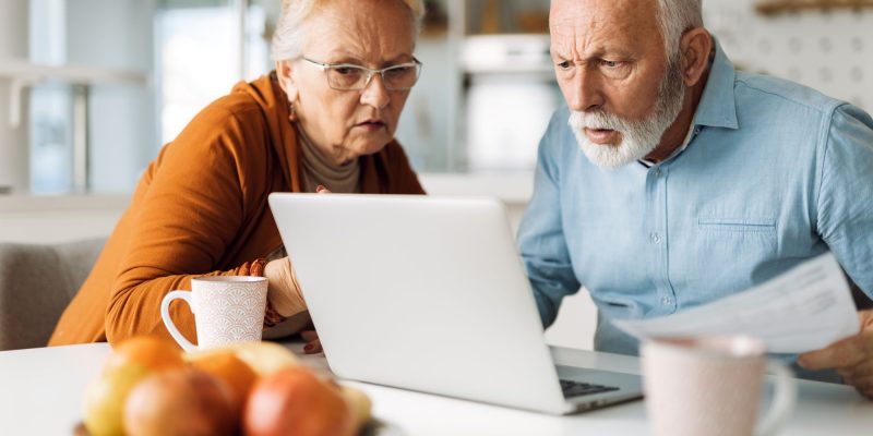 senior couple confused and looking at a computer screen
