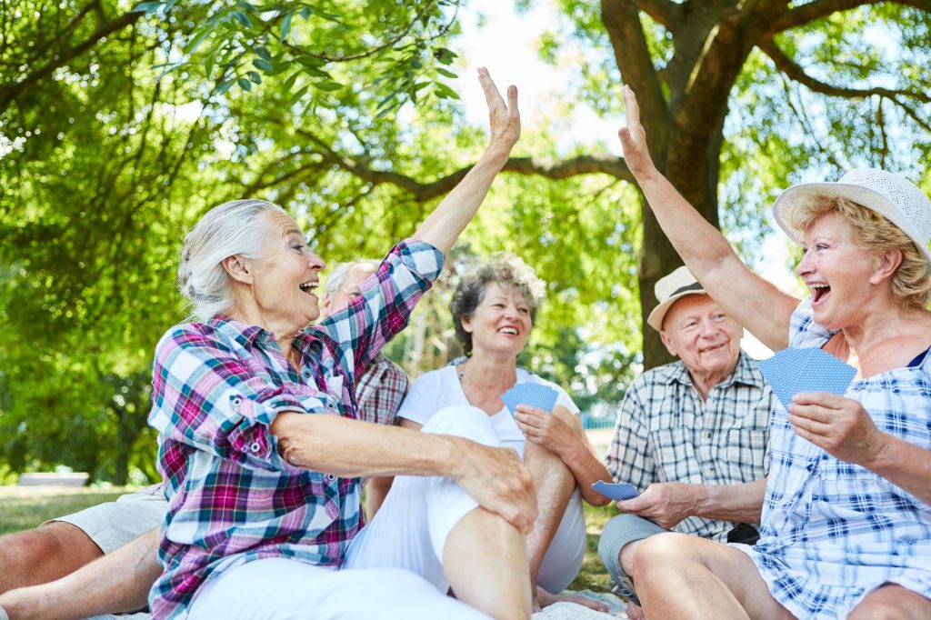 5 Questions to Ask Yourself Before Moving to a 55+ Active Adult Community two women playing a game and high fiving