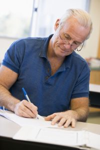 Senior man writing in to Toni Says about a Medicare and Long-Term Care question