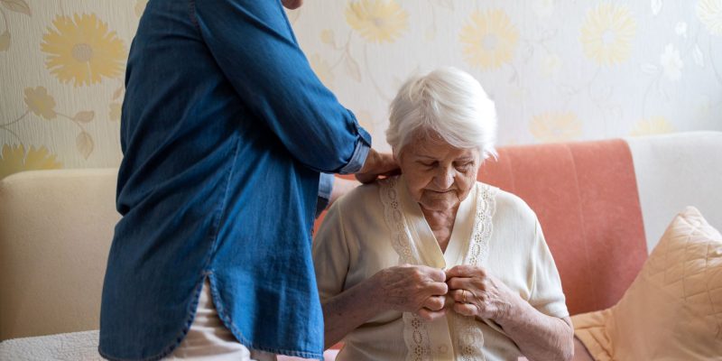 senior getting dressed with help