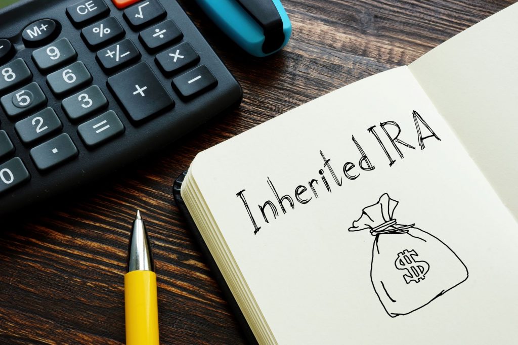 inherited ira from a parent written on a notebook with a money bag drawing