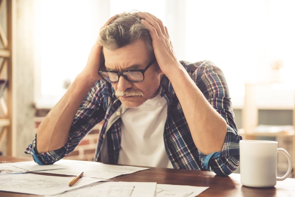man with Tinnitus  holding his head
