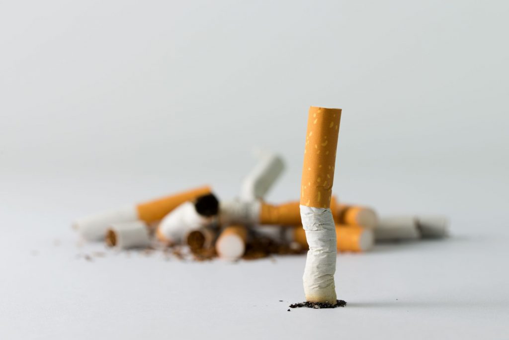quit smoking, cigarette stubbed out near a pile of broken cigarettes