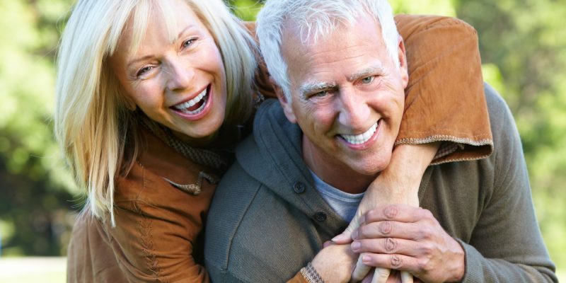 retired couple smiling outside