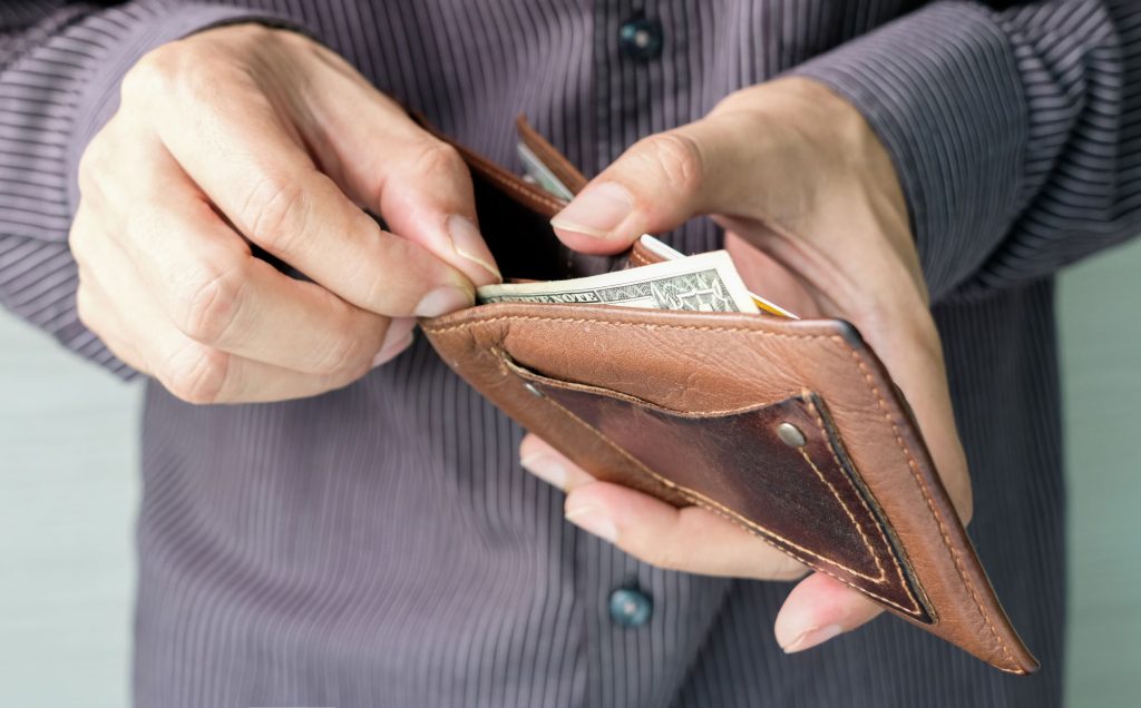 How to Find and Claim Your Family's Forgotten Assets open wallet with cash