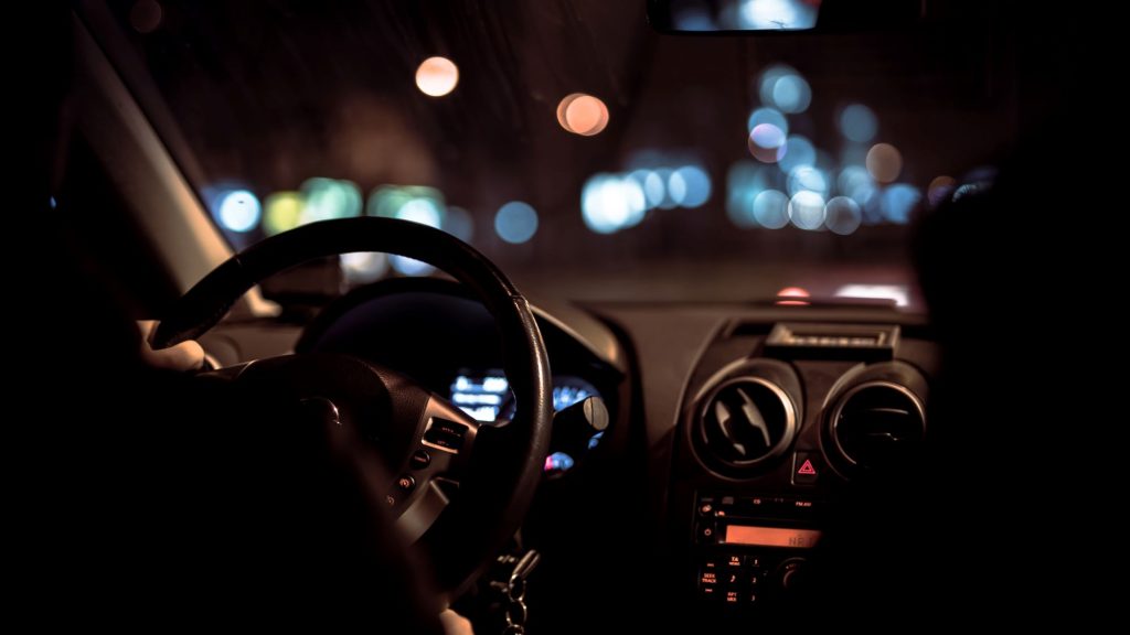 car at nighttime being driven by the working Boomer