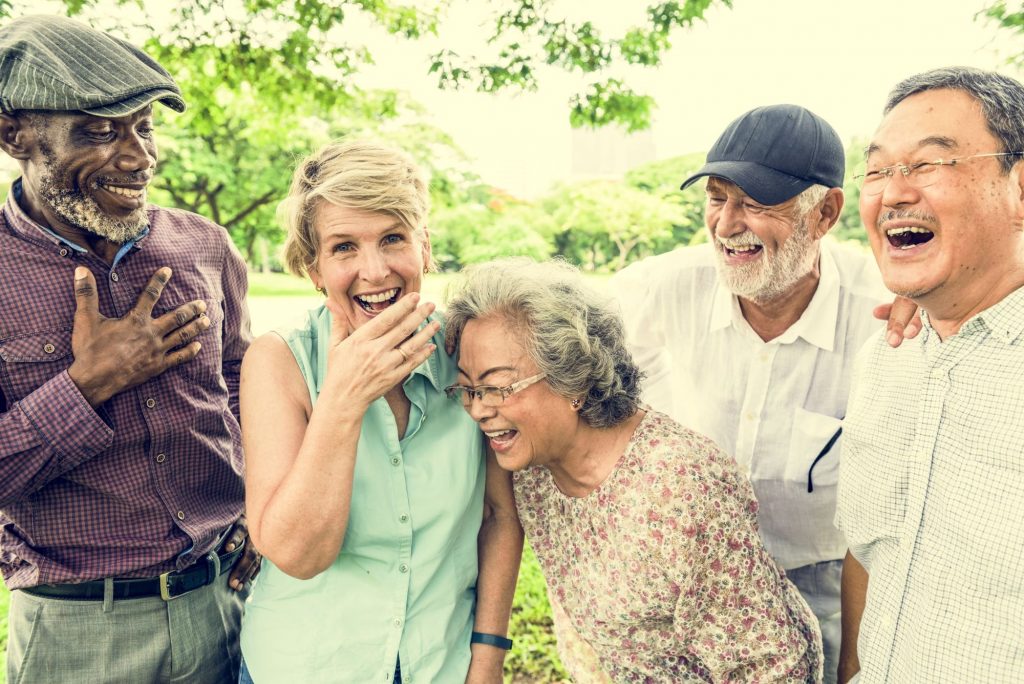 Group of multiethnic senior friends laughing and having fun.