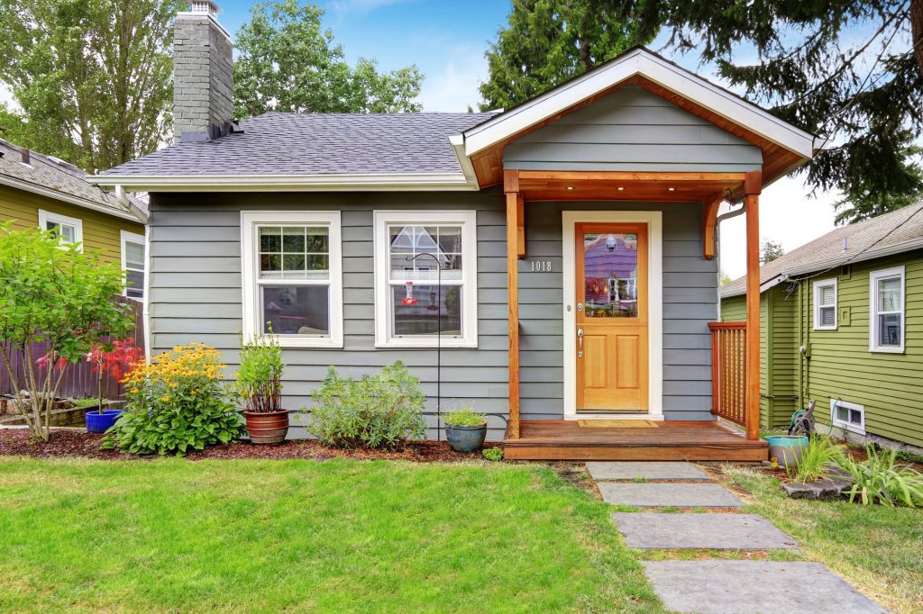 small gray house on a quiet neighborhood street