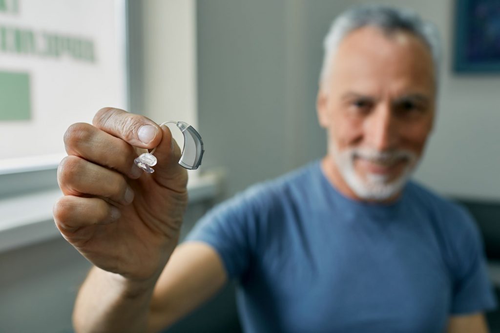 man holding a hearing aid