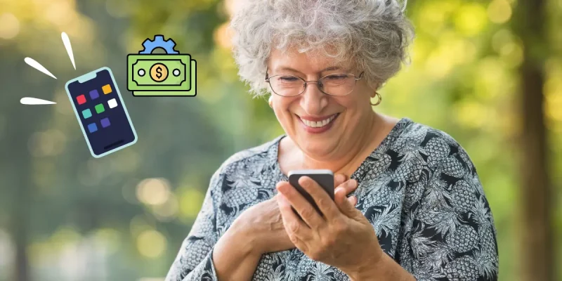 money management app photo, senior woman using phone and smiling outisde with phone and money management emojis next to her