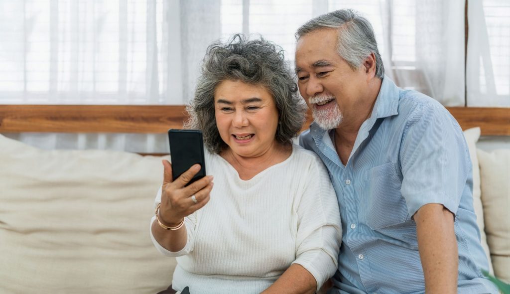 Asain senior couple on a video call on their smartphone