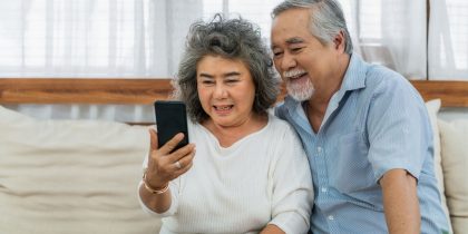 Asain senior couple on a video call on their smartphone